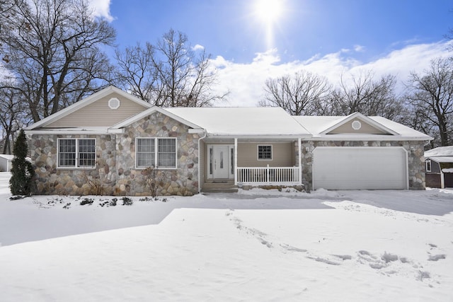 single story home featuring covered porch, stone siding, and an attached garage