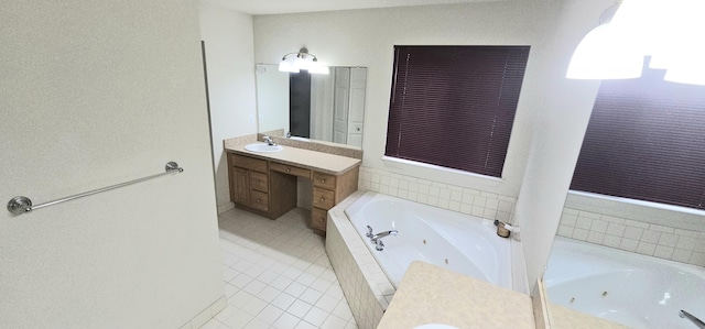 full bathroom with vanity, a tub with jets, and tile patterned floors