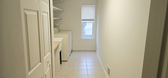 laundry area with light tile patterned floors, visible vents, washer and dryer, laundry area, and baseboards