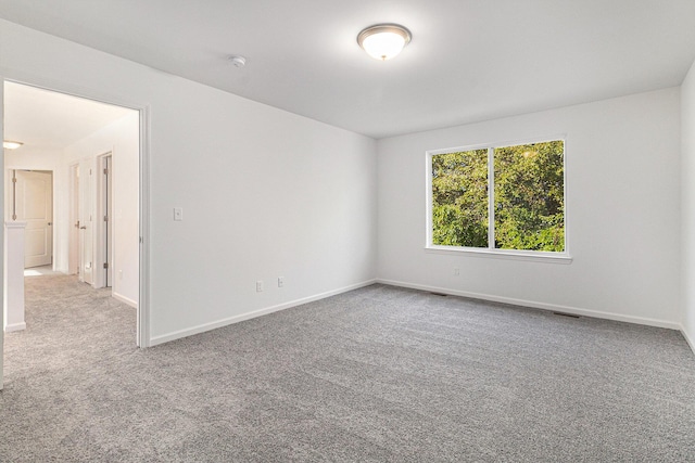 empty room with carpet floors and baseboards