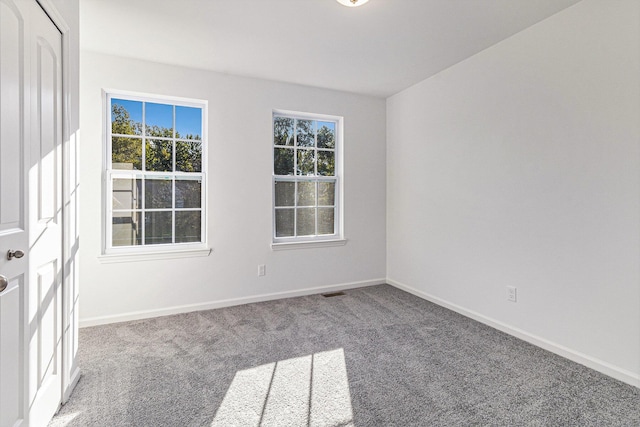 carpeted spare room with baseboards