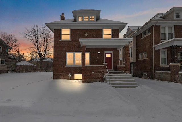 american foursquare style home with brick siding