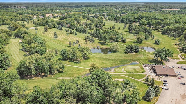 birds eye view of property with a water view and view of golf course