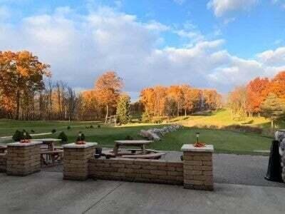 view of community with a patio, a yard, and an outdoor fire pit