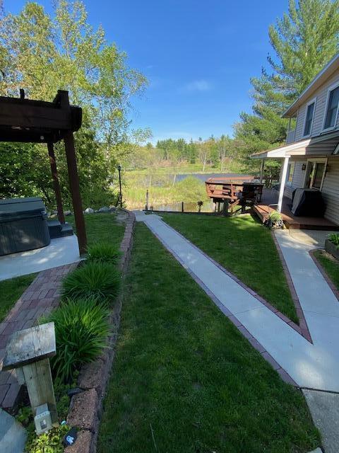 view of yard with a patio area and a hot tub