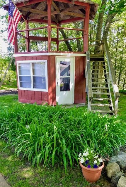 view of outbuilding featuring stairs