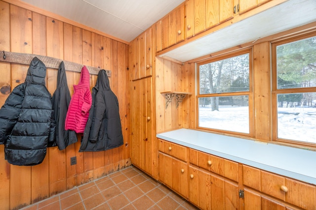 mudroom featuring wood walls and tile patterned floors