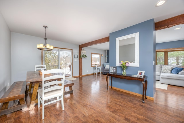 dining area featuring a chandelier, recessed lighting, wood finished floors, baseboards, and beam ceiling