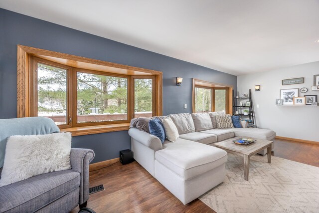 living room with baseboards and wood finished floors