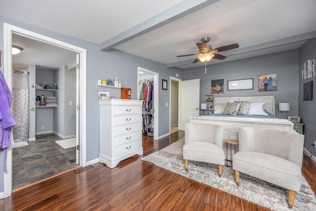 bedroom featuring baseboards, ceiling fan, wood finished floors, a spacious closet, and a closet