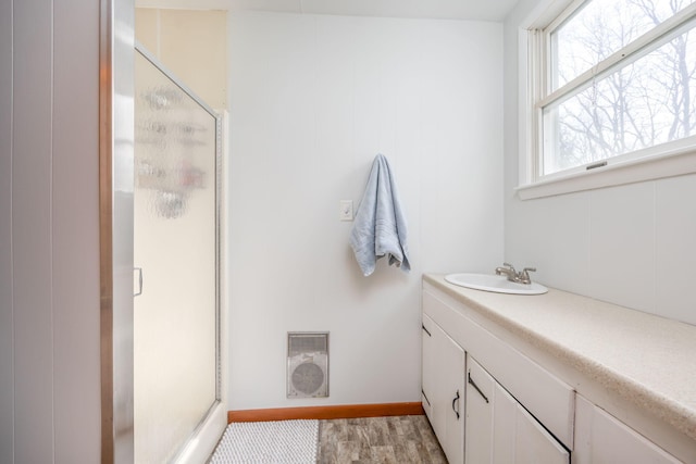 bathroom featuring a shower stall, visible vents, wood finished floors, and vanity