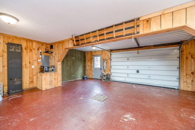 garage featuring wood walls