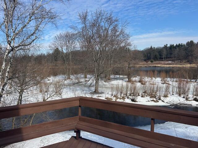 snow covered deck with a water view