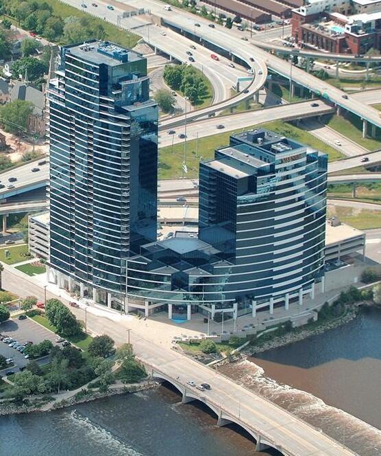 birds eye view of property featuring a water view and a city view