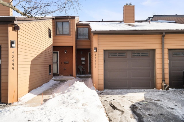 townhome / multi-family property featuring a chimney