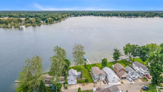 birds eye view of property with a water view and a residential view