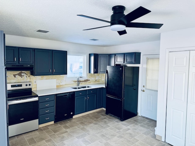 kitchen featuring blue cabinetry, light countertops, a sink, under cabinet range hood, and black appliances