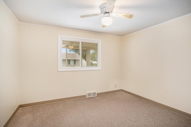 carpeted empty room featuring ornamental molding, visible vents, ceiling fan, and baseboards