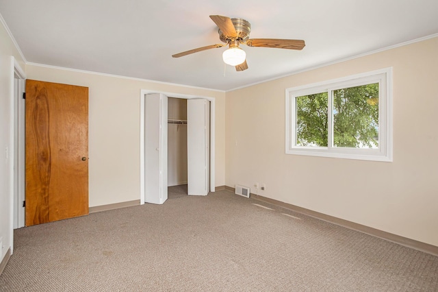 unfurnished bedroom featuring light colored carpet, crown molding, visible vents, and baseboards