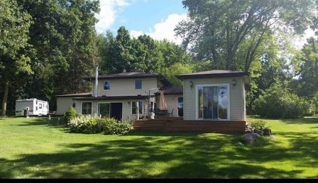 back of house featuring a yard and a deck