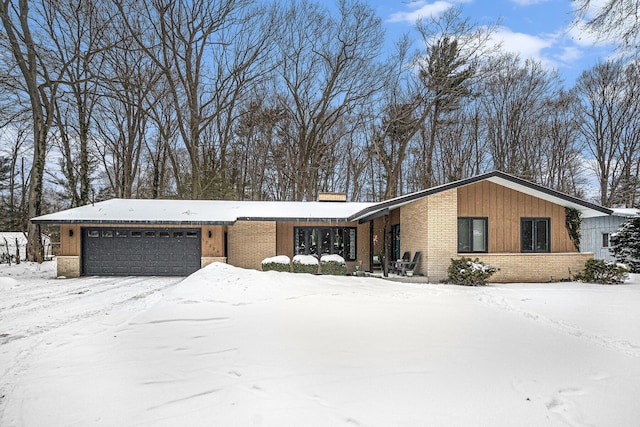 mid-century modern home with an attached garage and brick siding