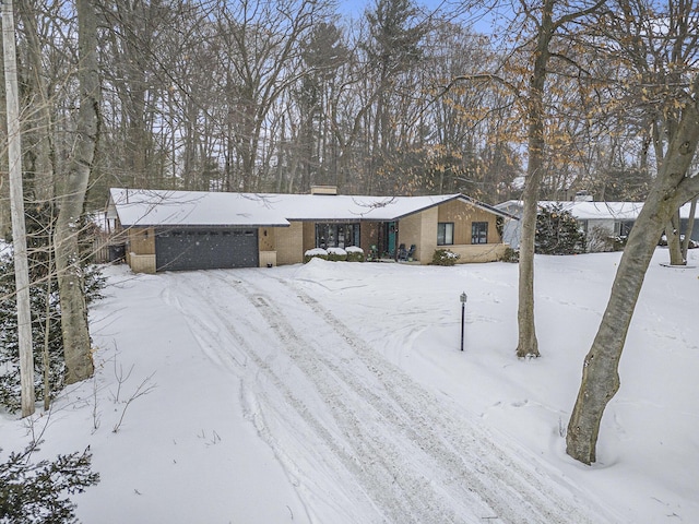 view of front of property featuring an attached garage and brick siding