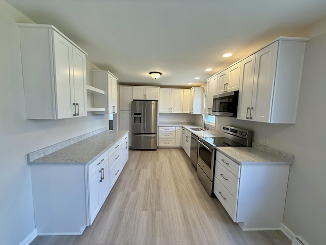 kitchen featuring a sink, stainless steel appliances, open shelves, and light countertops