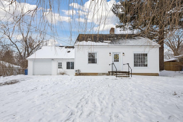 view of front of home featuring a garage and a chimney