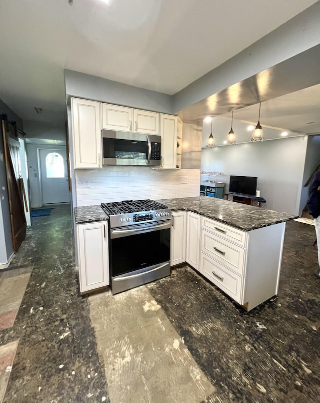 kitchen with stainless steel appliances, a peninsula, white cabinets, open floor plan, and hanging light fixtures