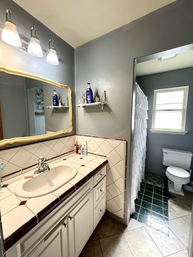 full bath featuring decorative backsplash, vanity, toilet, and tile patterned floors