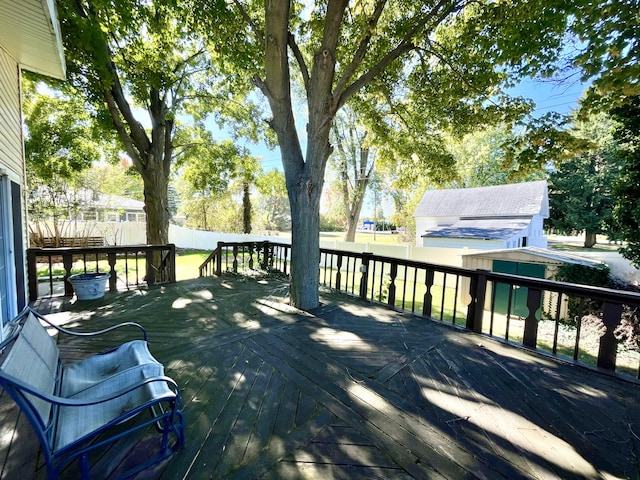 deck featuring an outbuilding, a shed, and a fenced backyard