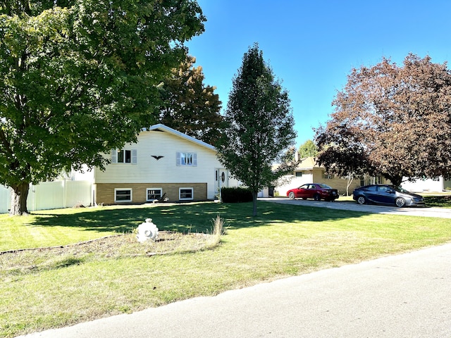 exterior space with a front lawn and fence