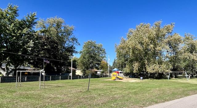 view of yard with playground community and fence