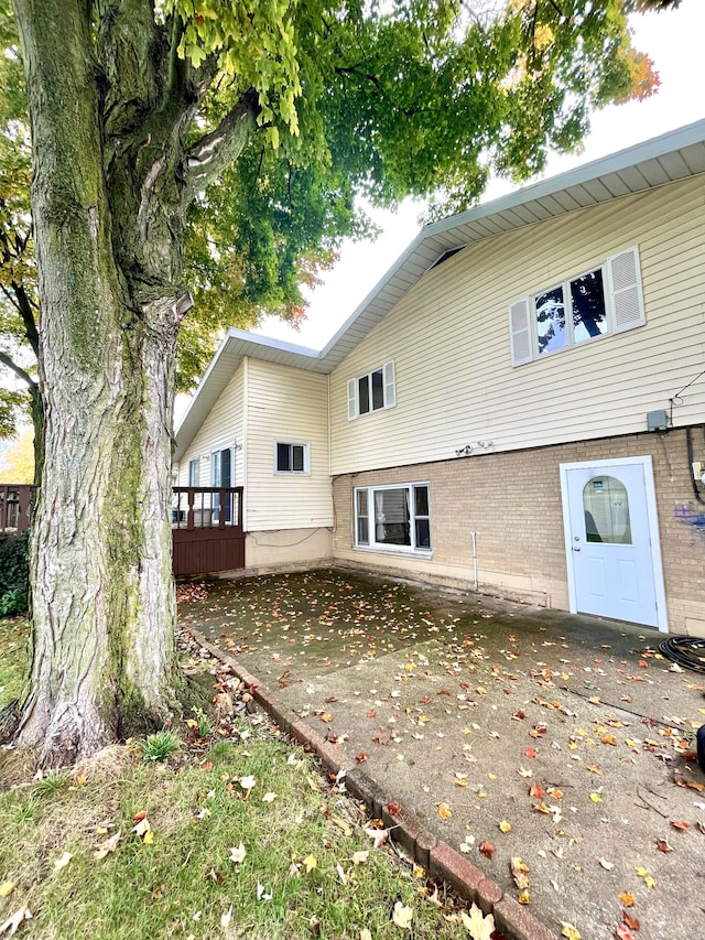 rear view of property featuring brick siding