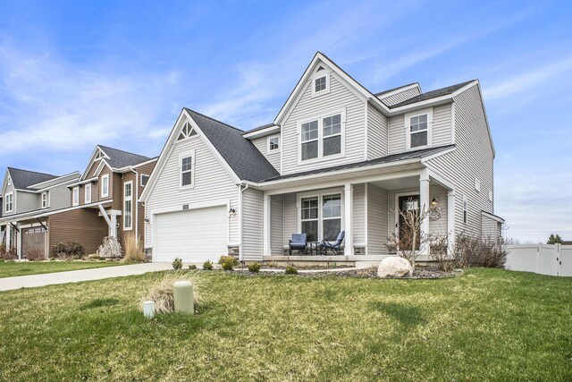 6745 Craftsman Square Dr NE, Rockford, MI 49341 - traditional home with fence, a garage, a porch, a front yard, and driveway
