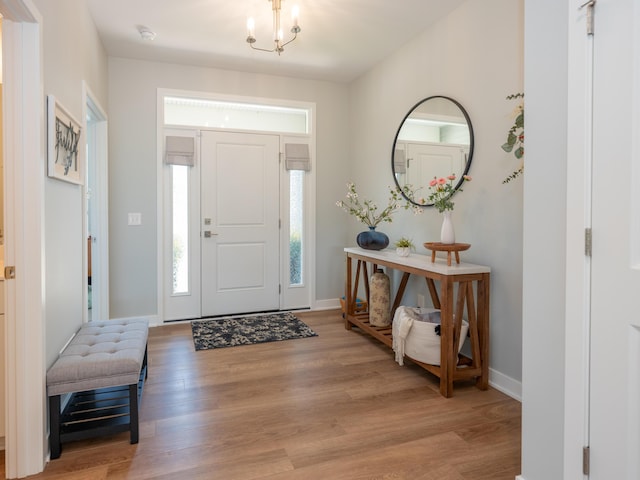 foyer entrance with baseboards and light wood-style floors