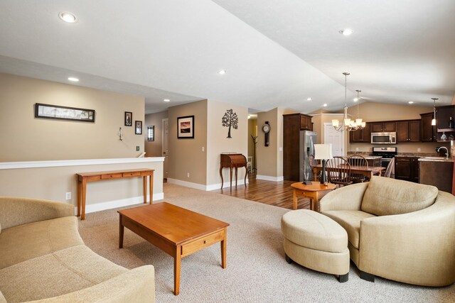 4588 Gordonshire NW, Grand Rapids, MI 49534 - living room featuring baseboards, recessed lighting, light colored carpet, a chandelier, and vaulted ceiling