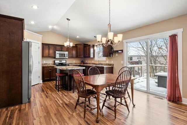 4588 Gordonshire NW, Grand Rapids, MI 49534 - dining area featuring visible vents, wood finished floors, recessed lighting, a chandelier, and vaulted ceiling