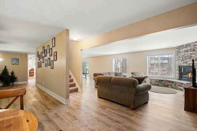 4588 Gordonshire NW, Grand Rapids, MI 49534 - living room with light wood-style floors, stairs, baseboards, and a healthy amount of sunlight
