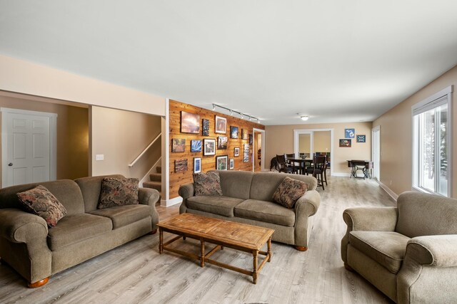 4588 Gordonshire NW, Grand Rapids, MI 49534 - living area featuring stairs, wooden walls, and light wood-style flooring