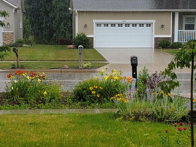 4588 Gordonshire NW, Grand Rapids, MI 49534 - view of yard featuring a garage and driveway
