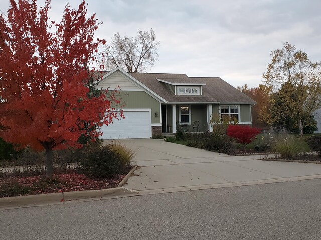 4588 Gordonshire NW, Grand Rapids, MI 49534 - view of front of home featuring a garage, driveway, and stone siding