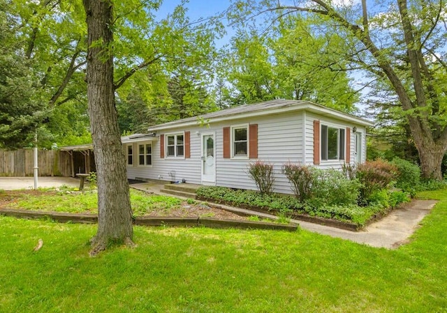 ranch-style house featuring a front yard and fence