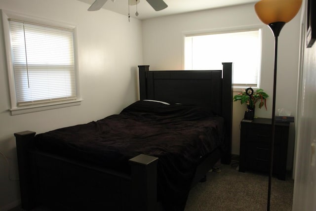 bedroom with a ceiling fan and light colored carpet