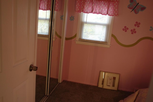 unfurnished bedroom with multiple windows, a closet, and carpet flooring