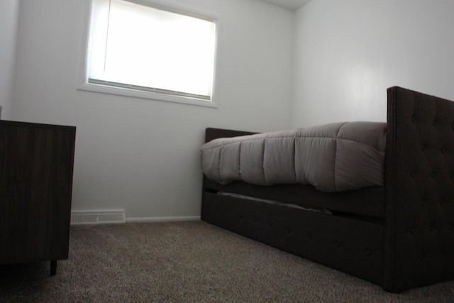 carpeted bedroom featuring visible vents