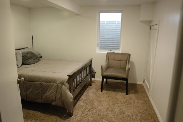 bedroom with light carpet and baseboards