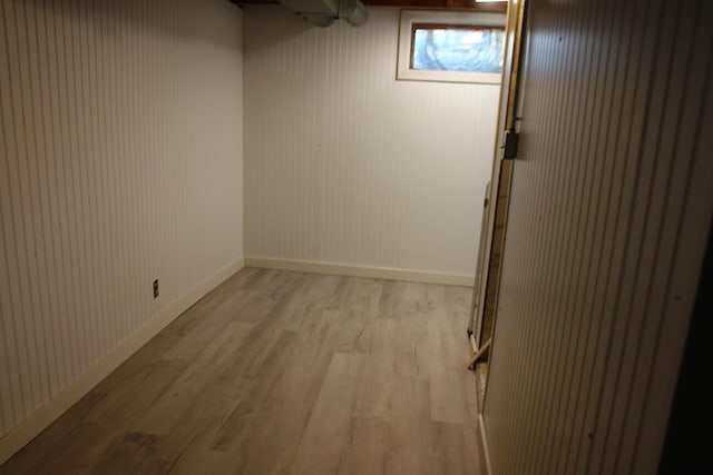 below grade area featuring light wood finished floors and baseboards