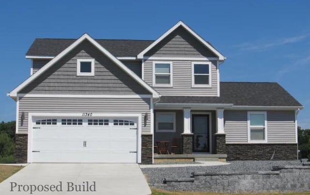 craftsman-style house with a garage, stone siding, and concrete driveway