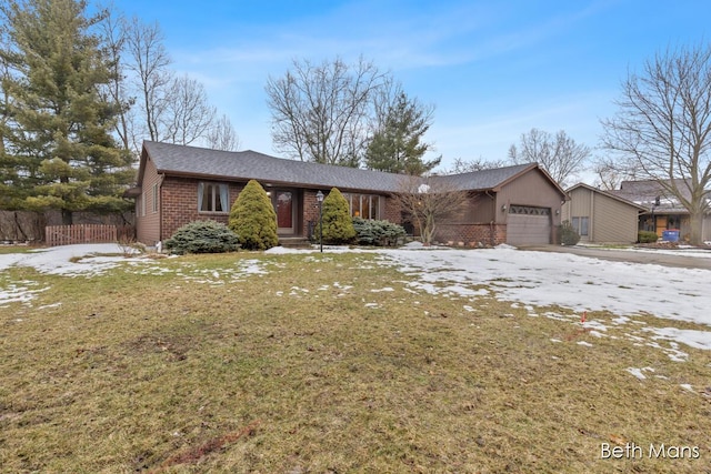 view of front facade featuring a garage, brick siding, fence, driveway, and a front lawn